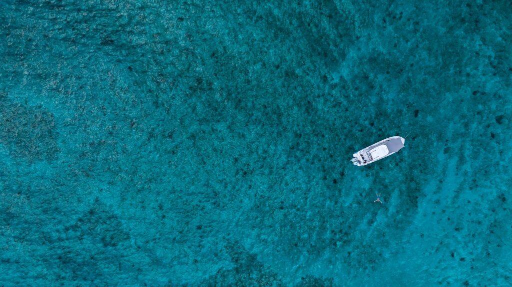 An aerial view of a boat in the ocean